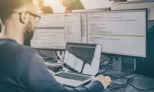 Programista analizuje kod, przygotowując się do pytań rekrutacyjnych tester.